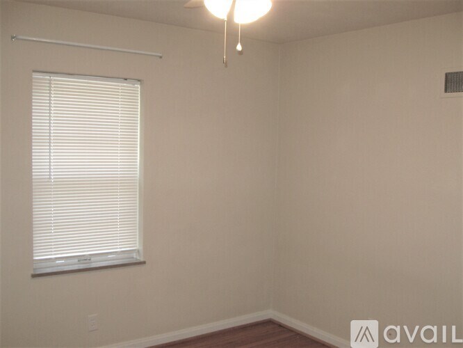 A white door with a glass panel and a gold handle.