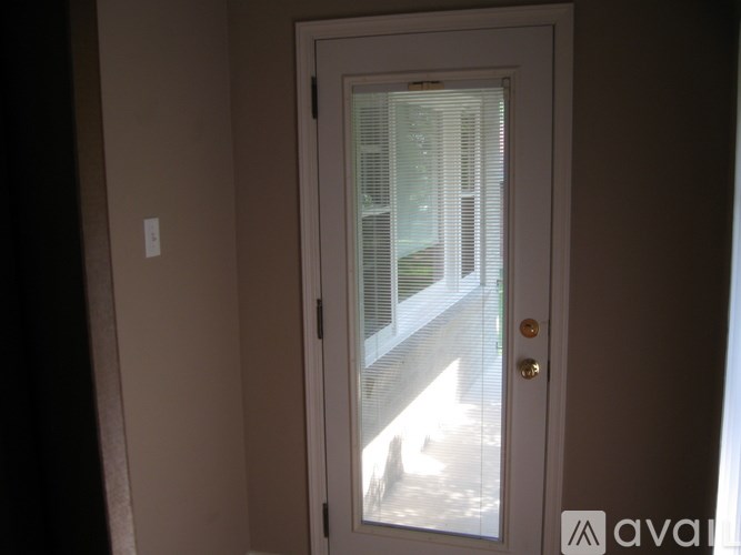 A white door with a glass window and a handle.