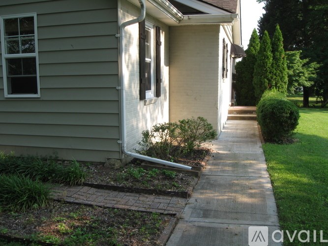 A house with a grey siding and a white door.