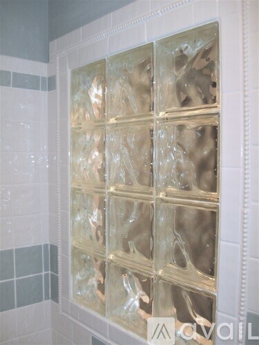 A glass block wall in a bathroom.
