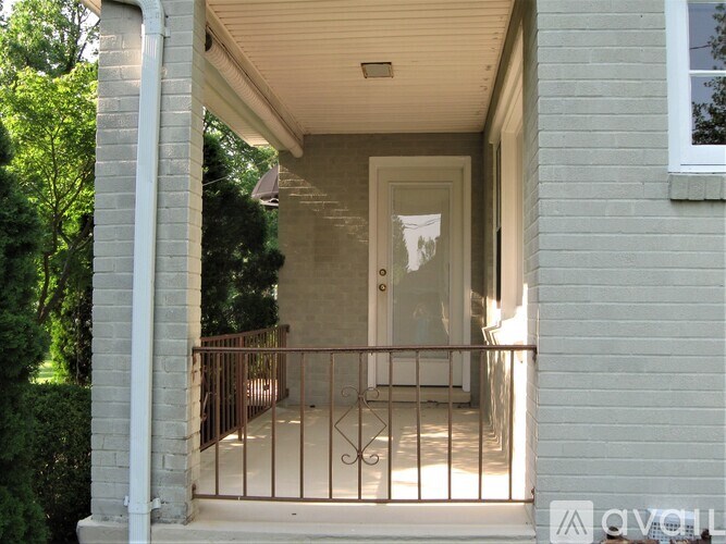 A white door is on the right side of a house.