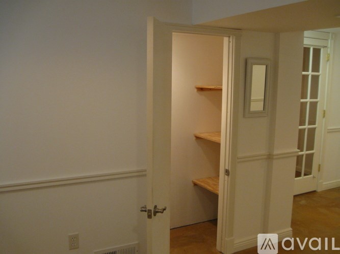 A white door with a mirror above it.