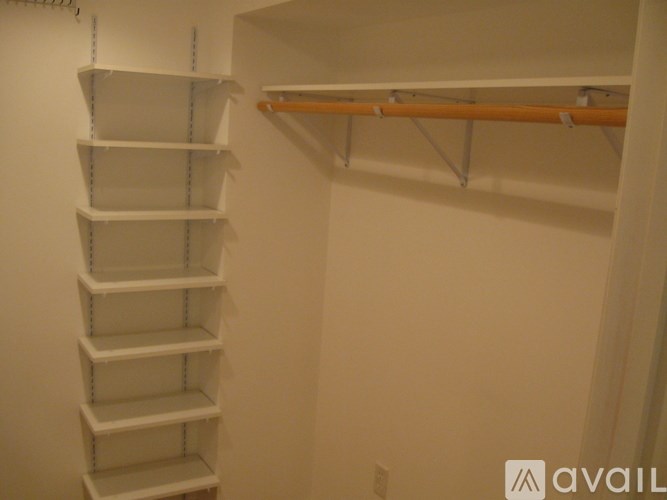 A white shelving unit with a wooden shelf on top.