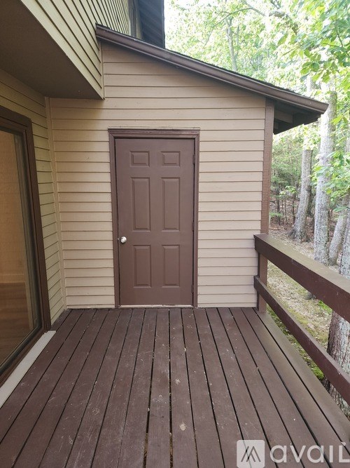 A brown door is on the side of a house.