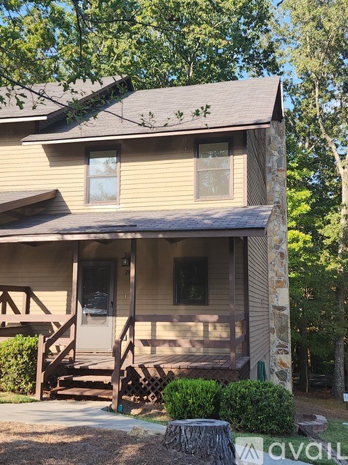 A house with a porch and a stone pillar.