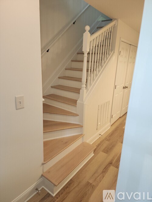 A staircase with wooden steps and white railings.