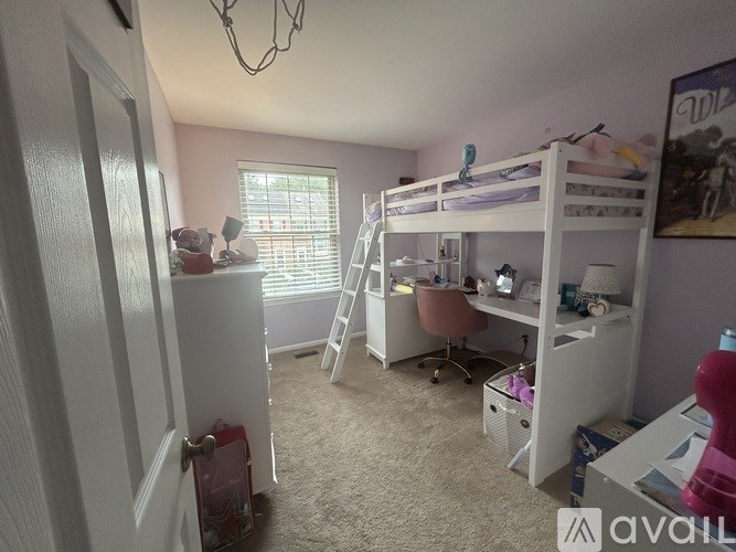 A bedroom with a bunk bed and a desk.