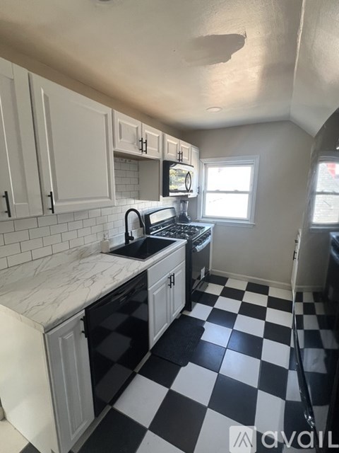 A kitchen with black and white checkered floor.