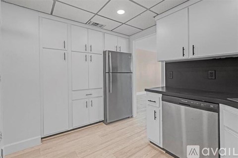 A kitchen with white cabinets and stainless steel appliances.