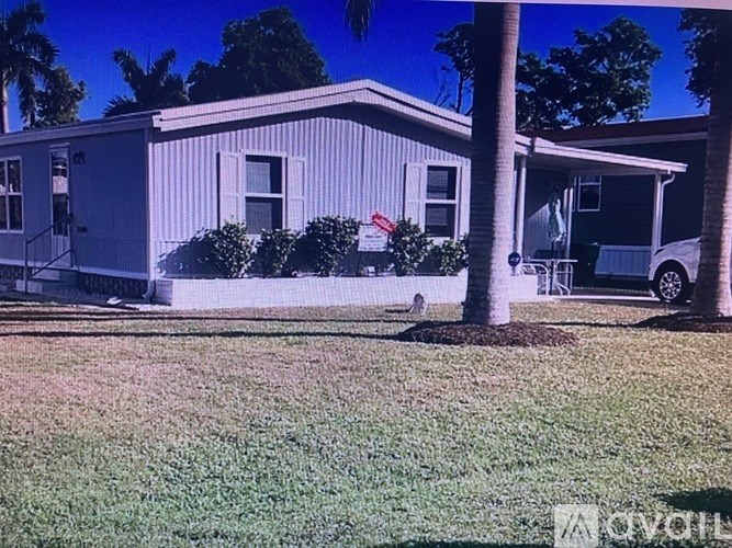 A house with a car parked in front.