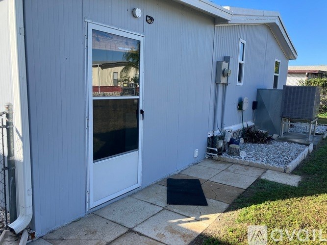 A white house with a door and a window.