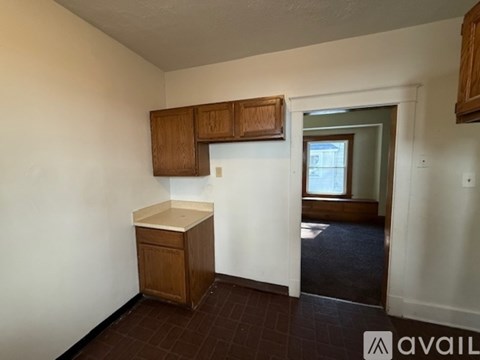A kitchen area with brown cabinets and a white countertop.