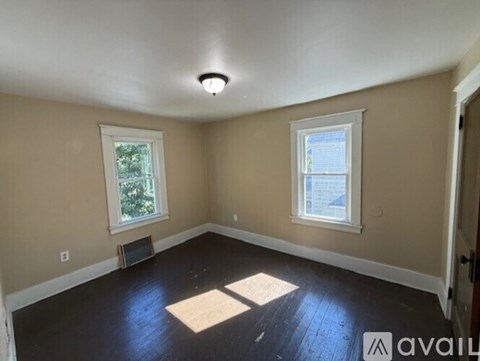 A room with a window and a door.