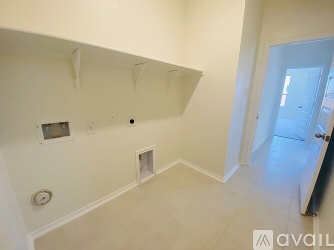 A white room with a doorway leading to another room.