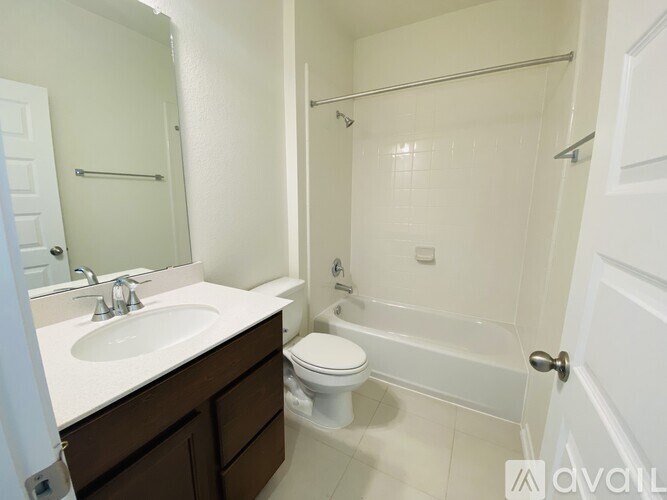 A bathroom with a toilet, sink, and bathtub.
