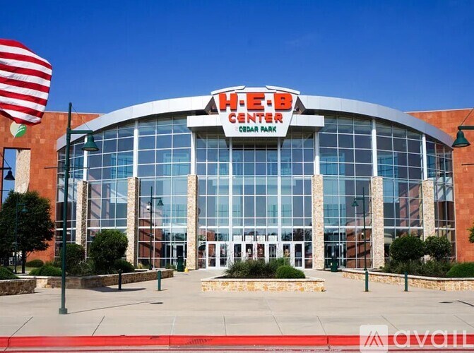 The HEEB Center is a large building with a glass facade and a red carpet in front.