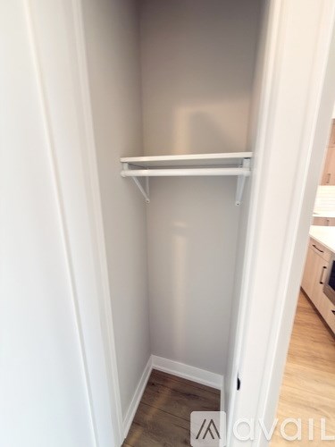 A white shelf in a room with white walls.