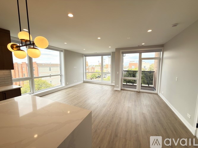 A spacious room with wooden floors and a large marble countertop.