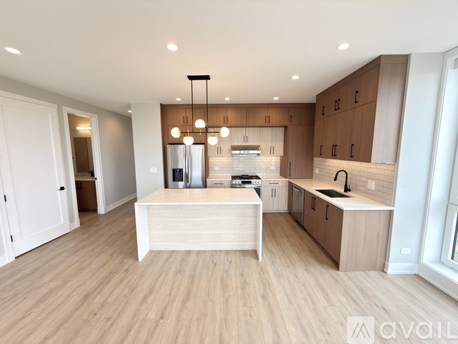 A modern kitchen with wooden cabinets and a central island.