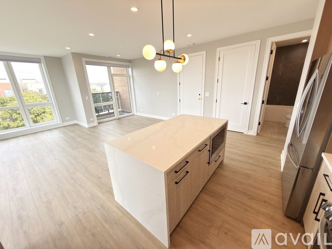 A kitchen with wooden cabinets and a large island.