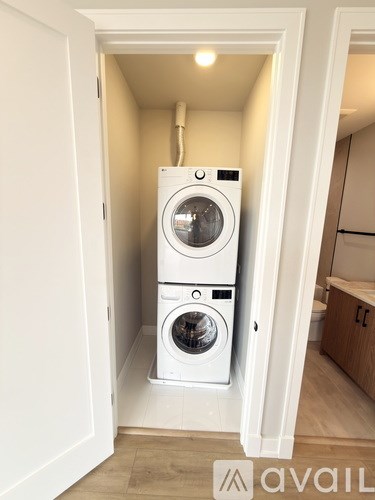A white washing machine and dryer in a small laundry room.