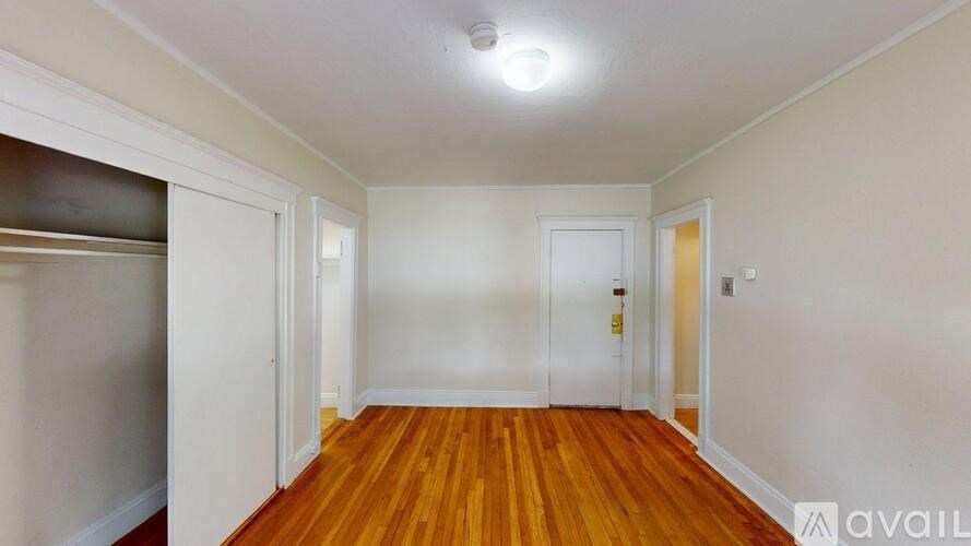 A room with wooden floors and white walls.