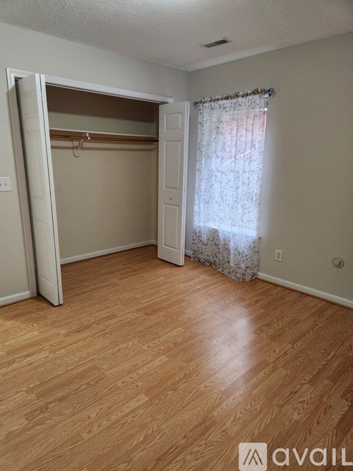 A room with a wooden floor and a white door.
