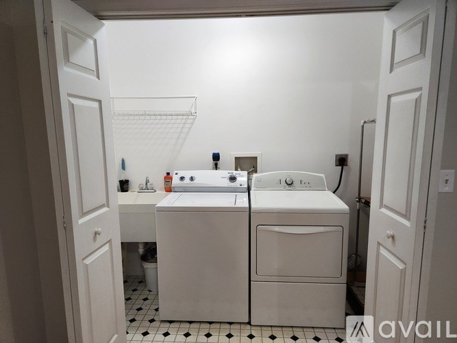 A bathroom with a white sink and toilet.