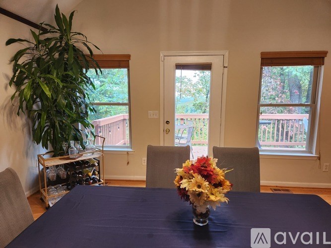 A dining room with a table set for four.