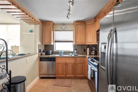 A kitchen with wooden cabinets and stainless steel appliances.