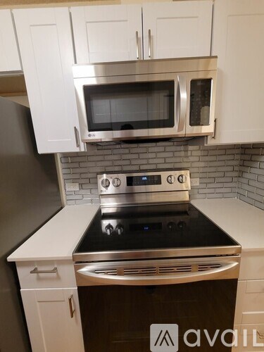 A kitchen with a stove top oven and microwave above it.