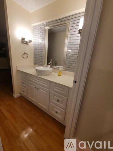 A bathroom with a sink and mirror.