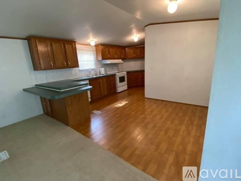A kitchen with wooden cabinets and a white refrigerator.