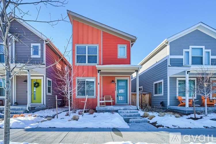 A row of houses with different colored front doors.