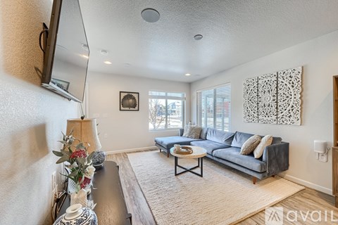 A living room with a grey couch and a coffee table.