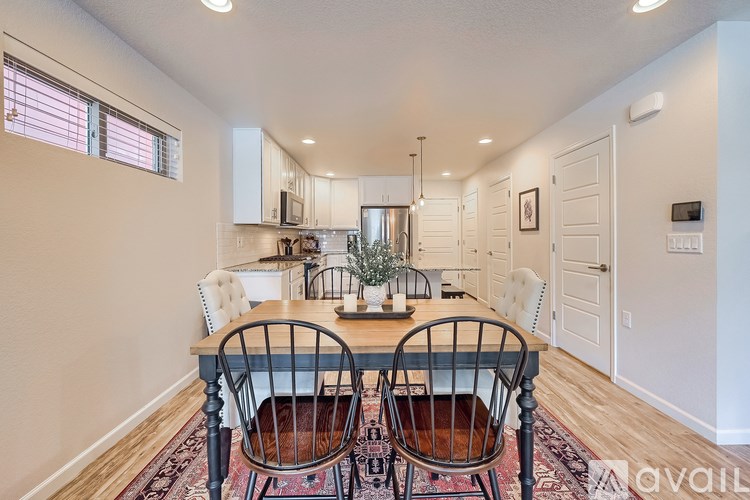 A dining room with a table set for two.