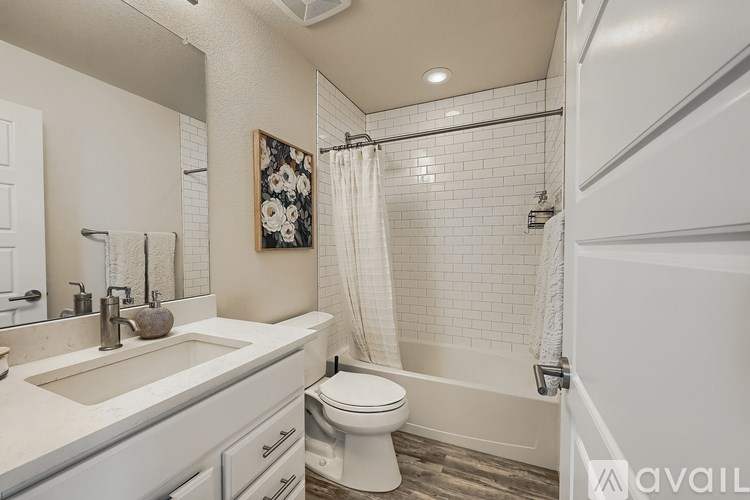 A bathroom with a toilet, sink, and shower.
