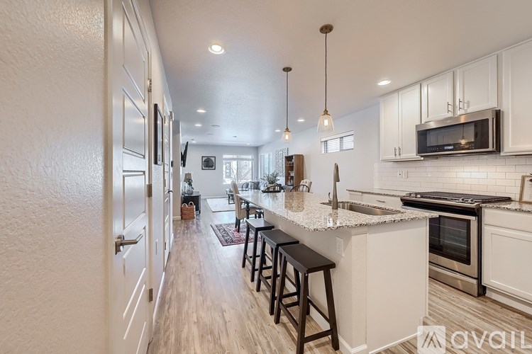 A kitchen with white cabinets and a white counter top.