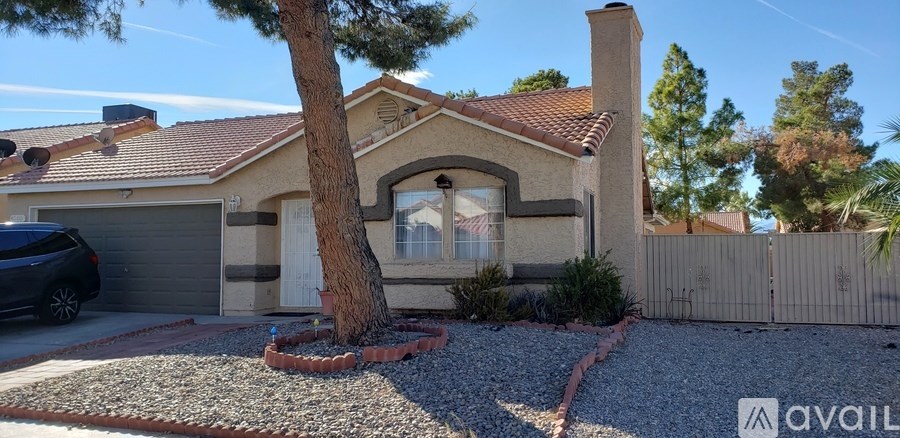A house with a tree in front and a car in the driveway.