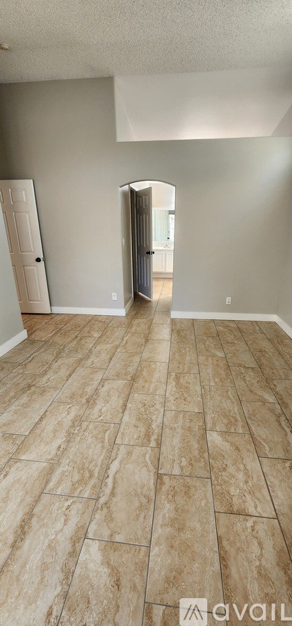 A room with a wooden floor and a white door.