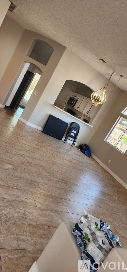 A living room with a large mirror and a chandelier.