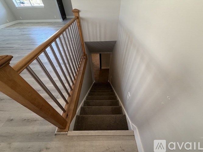 A staircase with wooden railings leads to a small landing.