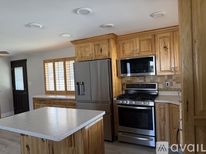 A kitchen with wooden cabinets and stainless steel appliances.