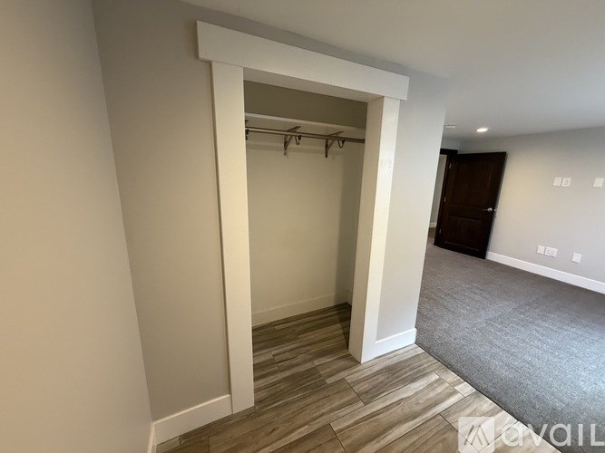 A room with a white doorway leading to another room.