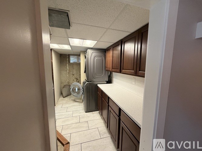 A kitchen with brown cabinets and a white countertop.