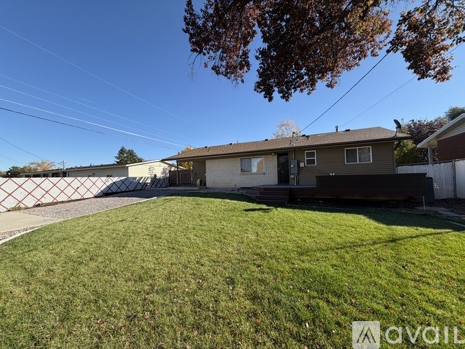 A room with wooden flooring and a window on the right side.