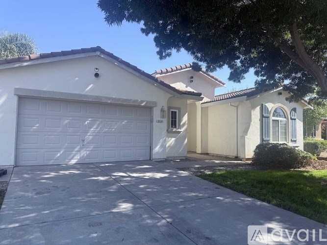 A house with a white garage door is for sale.