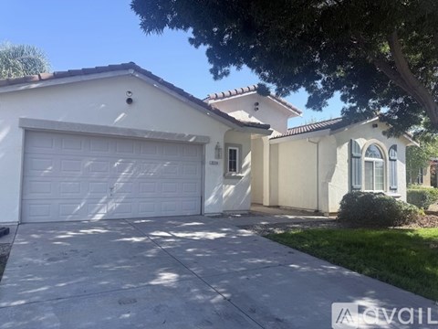 A house with a white garage door is for sale.