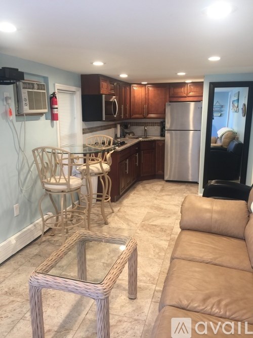A kitchen with a refrigerator, microwave, and oven.
