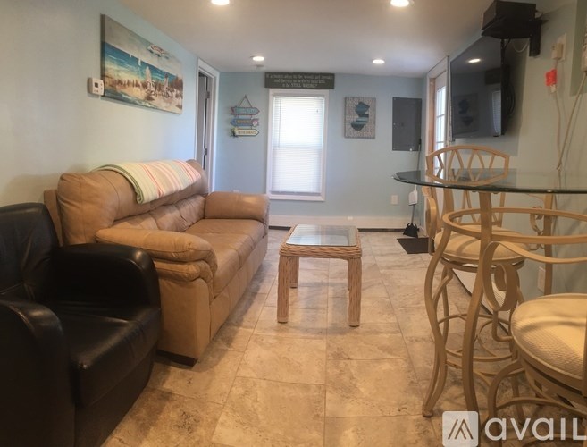 A living room with a couch, chairs, and a coffee table.